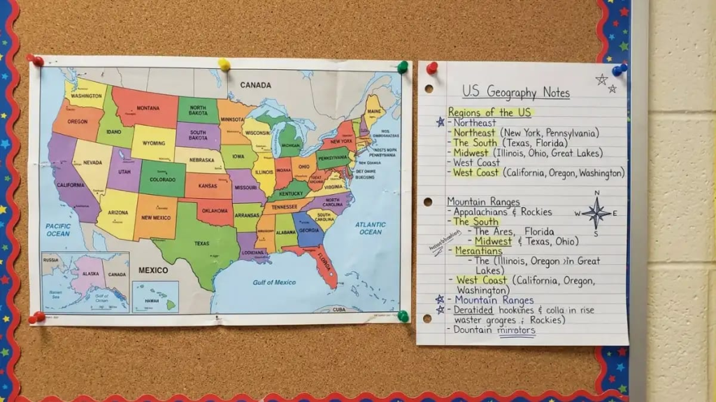 Printed map of the United States pinned to a classroom wall beside a student's notes